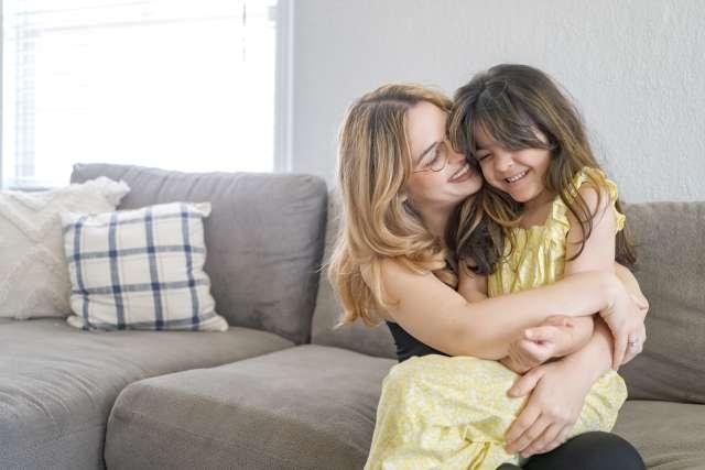 Mom Klarissa Hope hugs her smiling daughter, Raylee Osuna.